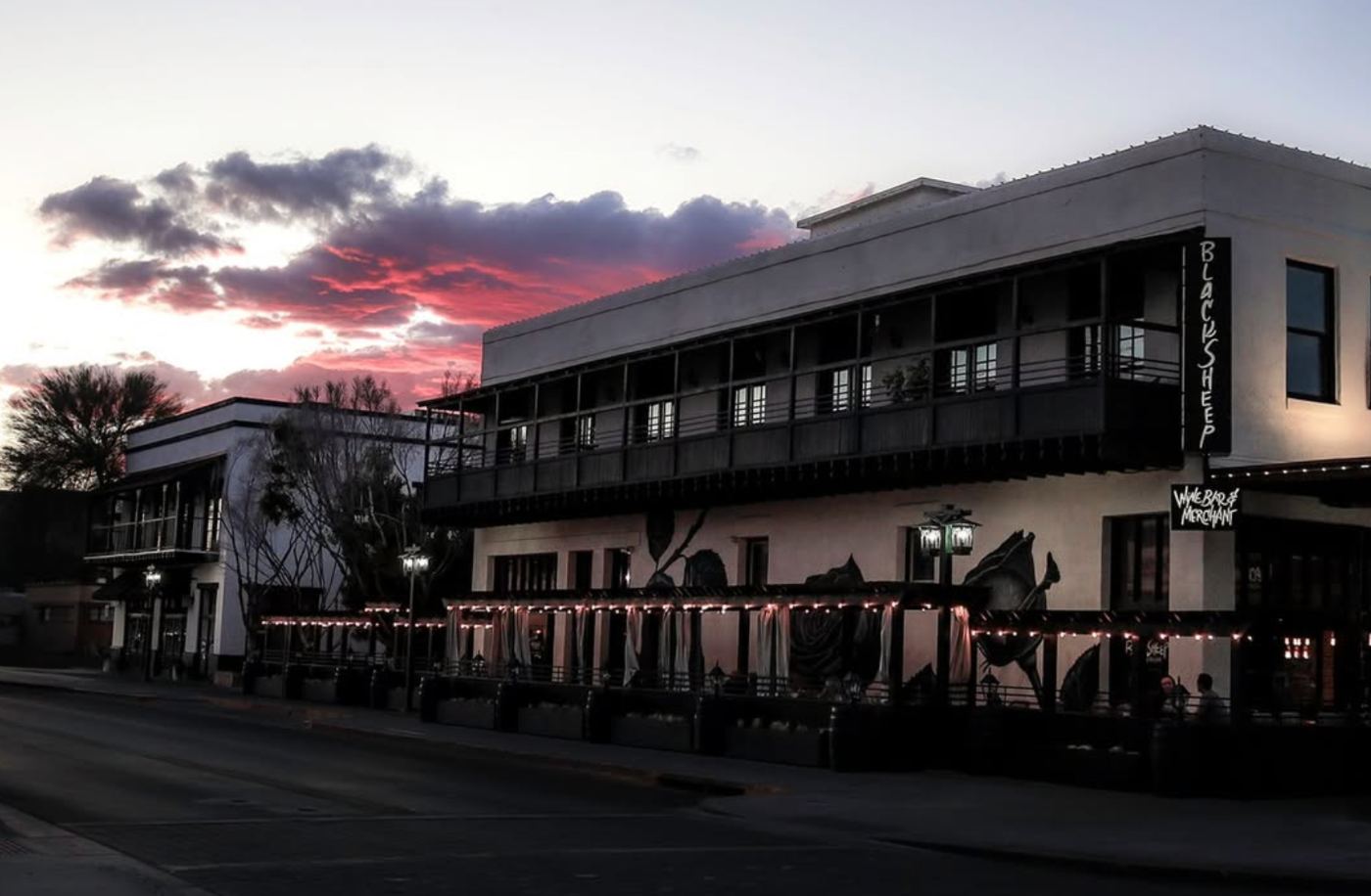 Black Sheep / Wine Bar & Merchant building at sunset with string lights on the patio
